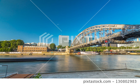 The Austerlitz viaduct in Paris timelapse hyperlapse, seen from bank of the river Seine with a metro train passing 130802983