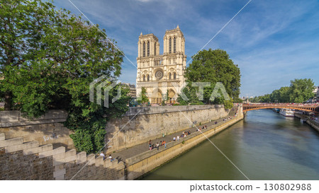 Front facade of cathedral of Notre Dame de Paris, with square full of people in front timelapse hyperlapse Front facade of cathedral of Notre Dame de Paris, with square full of people in front timelapse hyperlapse 130802988