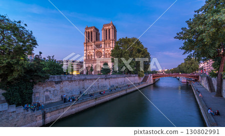 Front view of Notre Dame De Paris cathedral day to night timelapse after sunset. 130802991