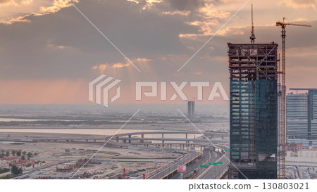 Sunrise aerial view of Financial center road morning timelapse with under construction building Sunrise aerial view of Financial center road morning timelapse with under construction building 130803021