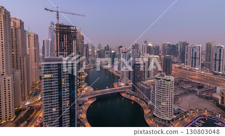 Beautiful aerial top view day to night transition timelapse of Dubai Marina canal 130803048