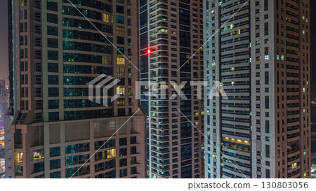 Scenic glowing windows of skyscrapers at night timelapse 130803056