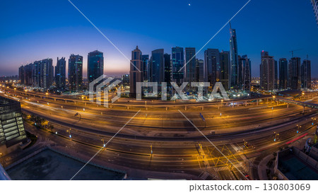 Aerial view of Jumeirah lakes towers skyscrapers night to day timelapse with traffic on sheikh zayed road. 130803069