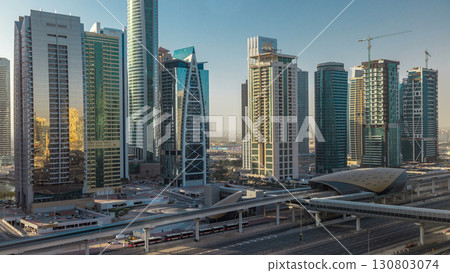 Aerial view of Jumeirah lakes towers skyscrapers during sunrise timelapse with traffic on sheikh zayed road. 130803074