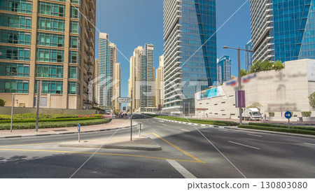Dubai Marina with Skyscrapers timelapse hyperlapse and traffic on the street near concrete road bridge through the canal 130803080