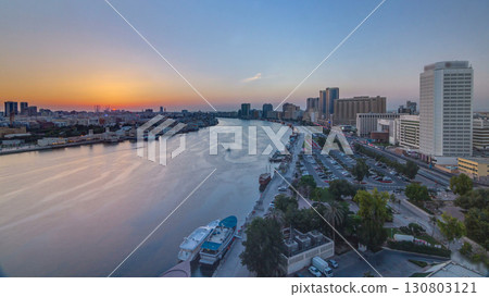 Dubai creek landscape at sunset timelapse with boats and ship near waterfront 130803121