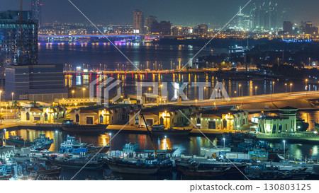 Dubai creek landscape night timelapse with boats and ship near waterfront Dubai creek landscape night timelapse with boats and ship near waterfront 130803125