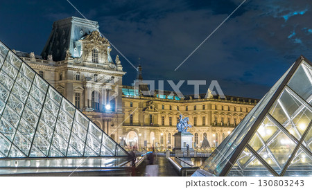 View of famous Louvre Museum with Louvre Pyramid at night timelapse hyperlapse. Paris, France View of famous Louvre Museum with Louvre Pyramid at night timelapse hyperlapse. Paris, France 130803243