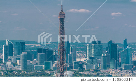 Aerial view from Montparnasse tower with Eiffel tower and La Defense district on background timelapse in Paris, France. Aerial view from Montparnasse tower with Eiffel tower and La Defense district on background timelapse in Paris, France. 130803314