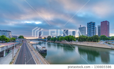 Eiffel Tower sunrise timelapse with boats on Seine river and in Paris, France. Eiffel Tower sunrise timelapse with boats on Seine river and in Paris, France. 130803386