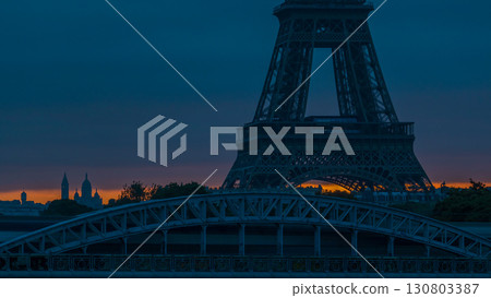 Eiffel Tower sunrise timelapse with boats on Seine river and in Paris, France. Eiffel Tower sunrise timelapse with boats on Seine river and in Paris, France. 130803387