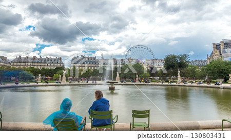 People relaxing in Tuileries Palace open air park near museum timelapse hyperlapse. Paris, France 130803431