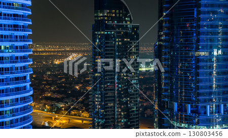 Buildings of Jumeirah Lakes Towers with traffic on the road aerial night timelapse. 130803456