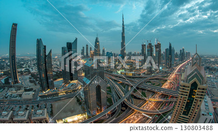 Modern skyscrapers and busy evening highways day to night timelapse in luxury Dubai city, Dubai, United Arab Emirates 130803488