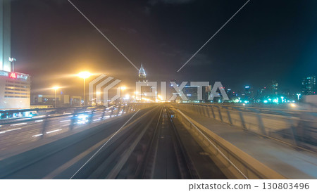 Front cabin POV view from modern driver-less metro train rush forward, along night Dubai, smooth timelapse. 130803496