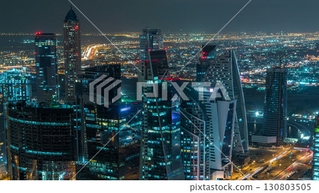 Dubai business bay towers illuminated at night timelapse. Rooftop view of some skyscrapers and new towers under construction. Dubai business bay towers illuminated at night timelapse. Rooftop view of some skyscrapers and new towers under construction. 130803505