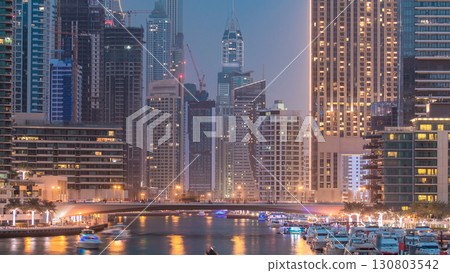 Evening Dubai marina city centre with floating vessels day to night timelapse Evening Dubai marina city centre with floating vessels day to night timelapse 130803542