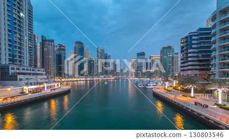 Evening Dubai marina city center with floating vessels day to night timelapse 130803546