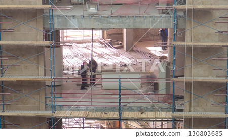Construction equipment material with scaffolding and tools inside the floor of high rising building timelapse 130803685