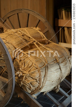Old handcart and rice bales 130803833