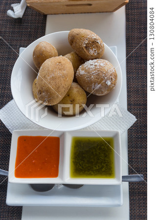 Portion of canarian potatoes (papas arrugadas) with red and green mojo sauce. Typical dish of the Canary Islands Portion of canarian potatoes (papas arrugadas) with red and green mojo sauce. Typical dish of the Canary Islands 130804084