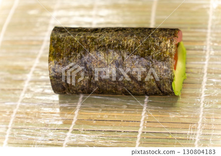 Freshly made sushi roll with salmon, tuna and avocado Freshly made sushi roll with salmon, tuna and avocado 130804183