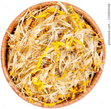 Mountain arnica in a small wooden bow isolated on white. 130804446