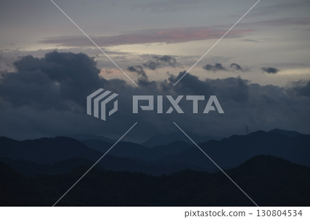 Rain clouds over the mountains and sunrise at dawn Rain clouds over the mountains and sunrise at dawn 130804534