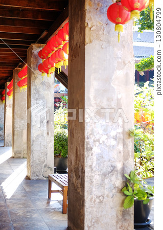 Beautiful traditional of red Chinese paper lantern with Chinese characters hanging on wooden ceiling in natural sunlight on Chinese New Year holiday Beautiful traditional of red Chinese paper lantern with Chinese characters hanging on wooden ceiling in natural sunlight on Chinese New Year holiday 130804799
