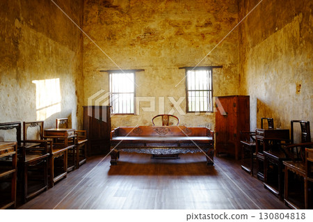 Antique old wooden furniture of Chinese style in vintage and rustic grunge concrete wall in living room with natural sunlight in Bangkok of Thailand 130804818