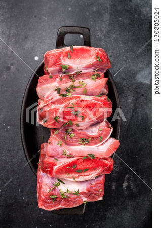 Raw Veal Short Ribs, fresh meat with thyme. black background. top view 130805024