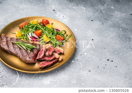 Grill Top Sirloin beef steak, rump steak with salad on a plate. grey background. top view 130805026
