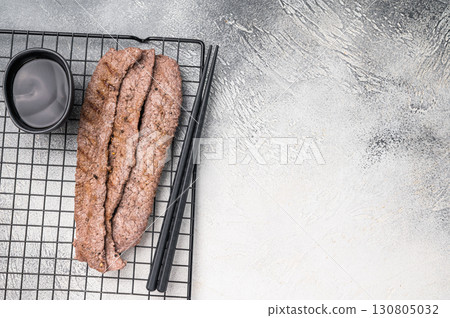 Japanese BBQ yakiniku, grilled wagyu bees strips. grey background. top view Japanese BBQ yakiniku, grilled wagyu bees strips. grey background. top view 130805032