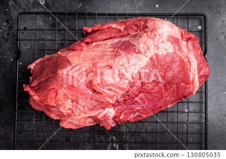 Close-up of raw boneless beef shank cuts, highlighting their tender texture and vibrant hue, ideal for culinary enthusiasts seeking quality ingredients. black background. top view Close-up of raw boneless beef shank cuts, highlighting their tender texture and vibrant hue, ideal for culinary enthusiasts seeking quality ingredients. black background. top view 130805035