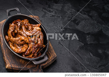 Korean Beef Meat Bulgogi Hot Plate. black background. top view 130805047