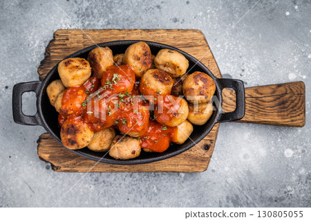 Roast meatballs served with tomato sauce. A classic comfort food in a skillet. grey background. top view 130805055