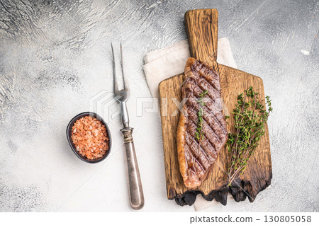 Grilled Top Sirloin, cooked rump beef steak. grey background. top view Grilled Top Sirloin, cooked rump beef steak. grey background. top view 130805058