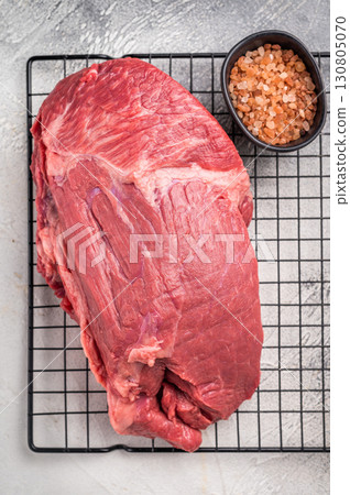 Raw Round beef meat cut, bottom round. grey background. Top view Raw Round beef meat cut, bottom round. grey background. Top view 130805070