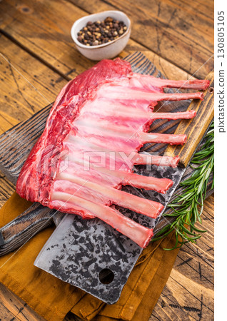 Butcher board with Raw lamb meat for chops steaks, fresh rack of mutton. wooden background. top view 130805105