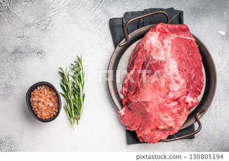 Beautifully arranged raw boneless beef shank pieces on a rustic platter, inviting creativity in the kitchen for delicious slow-cooked meals. grey background. top view Beautifully arranged raw boneless beef shank pieces on a rustic platter, inviting creativity in the kitchen for delicious slow-cooked meals. grey background. top view 130805194