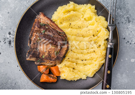 Slow cooked Beef short ribs, perfectly cooked and glazed with a rich barbecue sauce. grey background. top view Slow cooked Beef short ribs, perfectly cooked and glazed with a rich barbecue sauce. grey background. top view 130805195