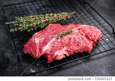 Raw hanging tender or onglet beef steak. black background. top view 130805223