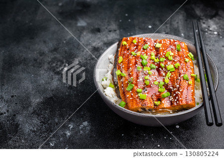 Unagi don, Unagidon Japanese grilled eel with rice in a bowl. black background. top view 130805224
