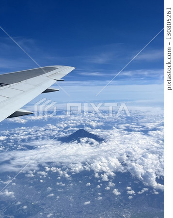 Mount Fuji and wings floating in the clouds seen from an airplane Mount Fuji and wings floating in the clouds seen from an airplane 130805261