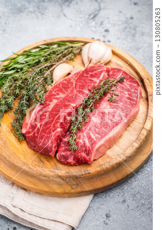 Raw beef marbled steak, Australian Oyster Top blade steak. grey background. top view Raw beef marbled steak, Australian Oyster Top blade steak. grey background. top view 130805263