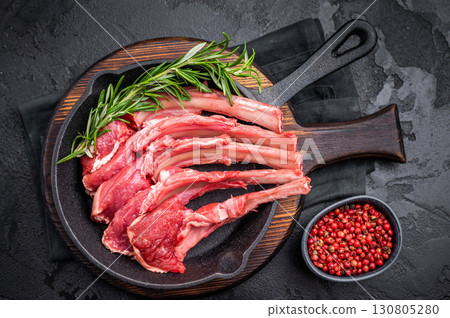 Ready for cooking Raw lamb meat chops, fresh mutton cutlets in a pan. black background. top view Ready for cooking Raw lamb meat chops, fresh mutton cutlets in a pan. black background. top view 130805280