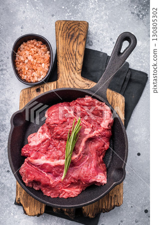 Ready for grilling Raw hanging tender or Hanger beef steak in a pan. grey background. top view Ready for grilling Raw hanging tender or Hanger beef steak in a pan. grey background. top view 130805302