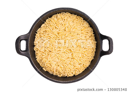Raw Orzo pasta, uncooked dry Italian risoni in a bowl isolated on white background. top view 130805348