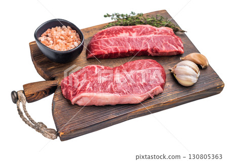 Raw Top blade steak, Fresh Beef shoulder Blade on wooden board isolated on white background. top view Raw Top blade steak, Fresh Beef shoulder Blade on wooden board isolated on white background. top view 130805363
