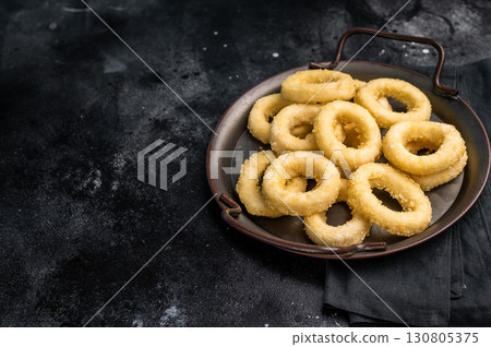 Ready for cooking Raw onion rings, uncooked vegetable. black background. top view 130805375
